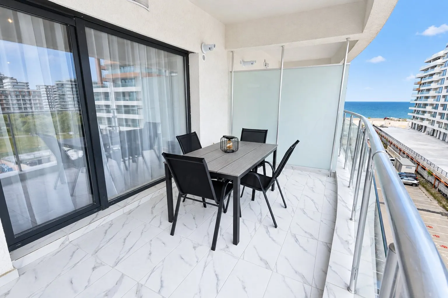 Balcony with a table for four, looking out over the sea and the beach, at Casa del Mar, Mamaia Nord
