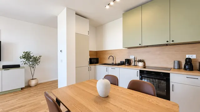 Kitchen with green cabinets, a wooden worktop and a wooden table, at Torontal, Timișoara