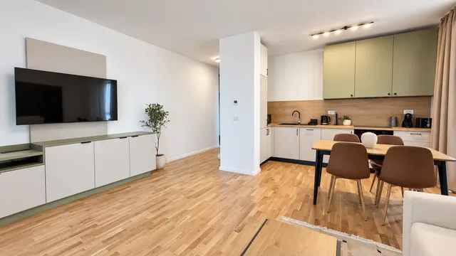 Living room open to the kitchen, with a TV and a large window, at Torontal, Timișoara