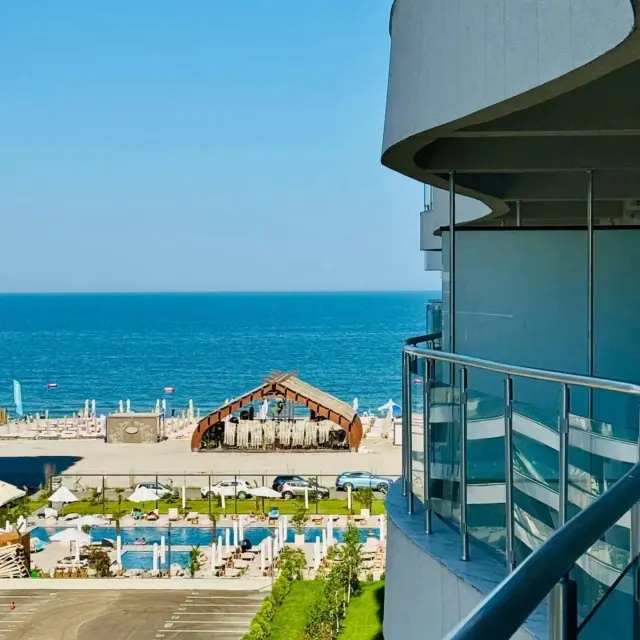 View from the balcony over the beach, the pools and the sea, at Casa del Mar, Mamaia Nord
