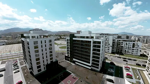Aerial view of the new Coresi apartment buildings with the mountains behind, at Coresi, Brașov