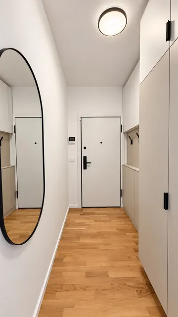Hallway with an oval mirror and built-in wardrobes, at Torontal, Timișoara